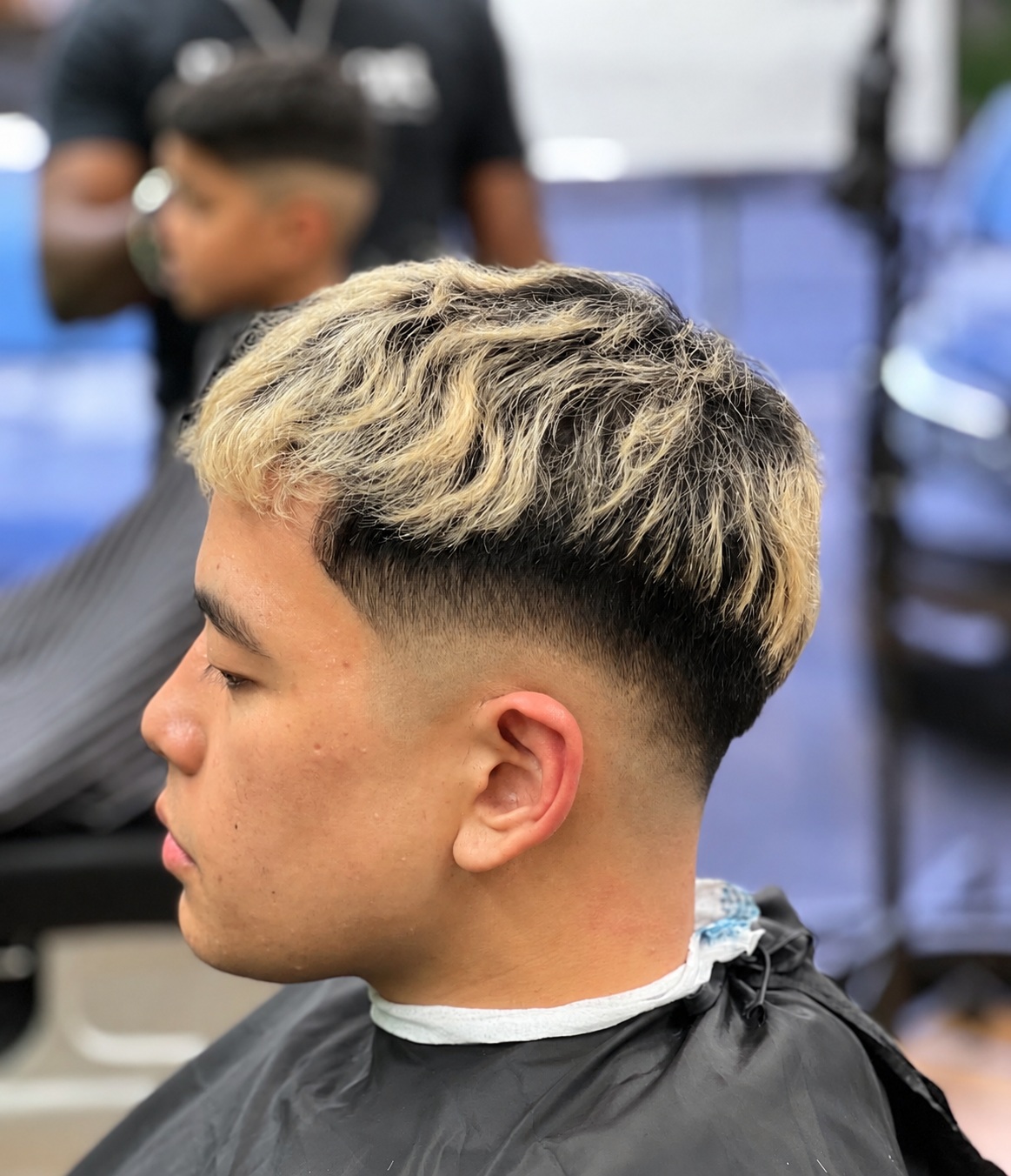 Blonde textured hair with a skin fade