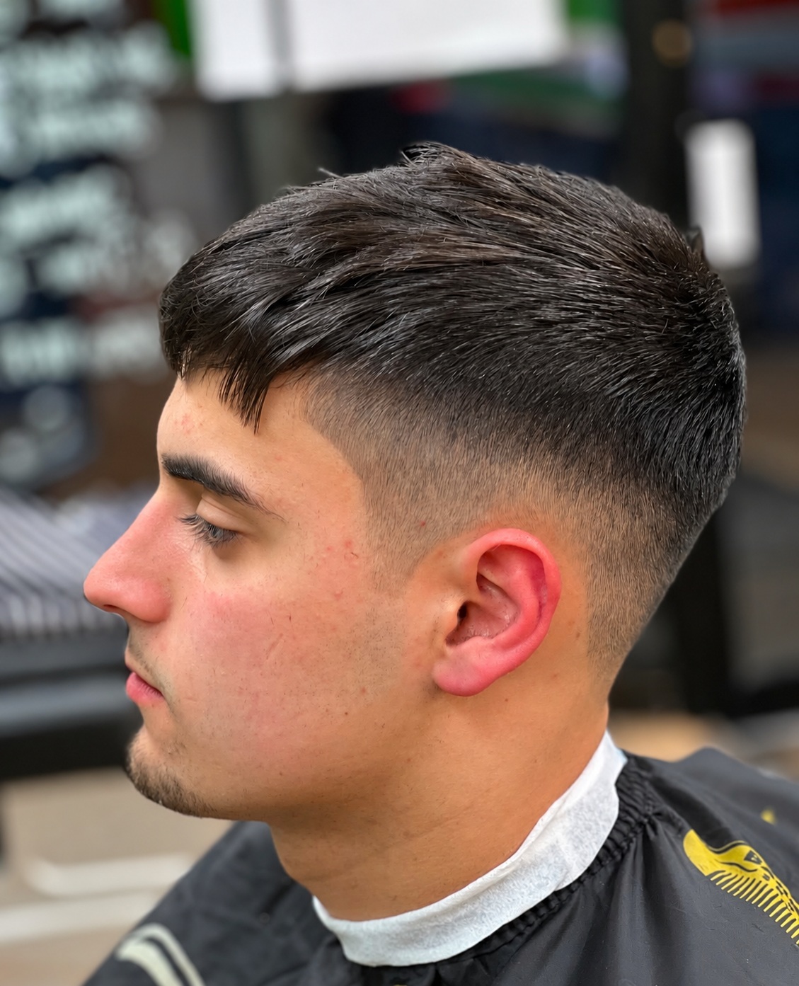 A short textured haircut with a skin fade